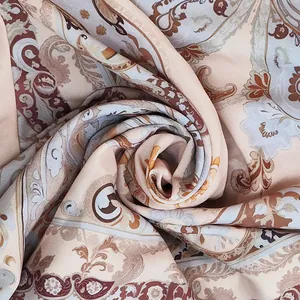 High-resolution macro detail of bohemian paisley and floral print fabric texture for tops