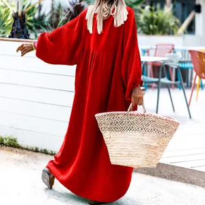 Stunning back view of a loose red resort style maxi dress with elegant lantern sleeves
