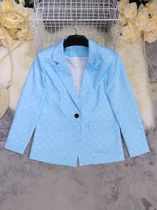 Close-up detail of a light blue polka dot long-sleeved blazer jacket with lapel collar