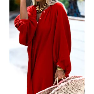 Close-up detail of a vibrant red loose-fit maxi resort dress showing textured fabric quality