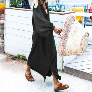 Elegant loose black long-sleeve maxi dress with textured fabric and button details