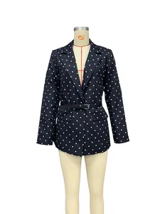 Front detail view of a stylish black and white polka dot blazer with waist belt.