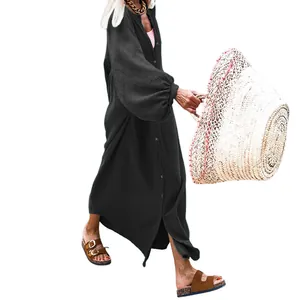 Full-length view of a black loose-fit button-up maxi dress with long sleeves.