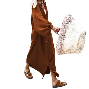 Side view of a loose rust-brown maxi dress with lantern sleeves and button detail.