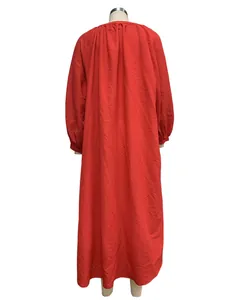 Detailed back view of a loose red oversized maxi dress with pleated fabric texture