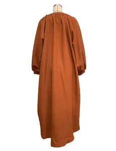 Detailed back view of a burnt orange loose-fit maxi dress for women's resort style