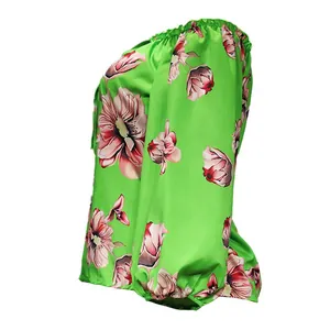 Side profile of a vibrant green floral print off-the-shoulder long-sleeved top for women.