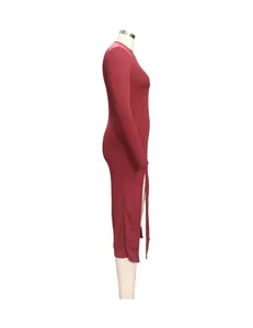 Side view of a burgundy long sleeve ribbed maxi dress with side slits on a mannequin