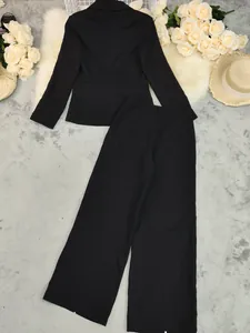 Back view of a classic black women's suit set with blazer and wide-leg trousers.