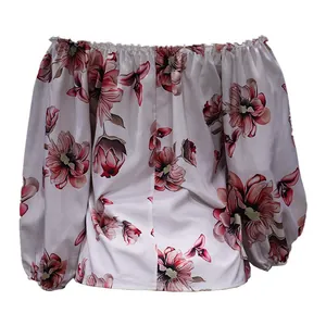 Detailed view of pink floral print on an off-the-shoulder long sleeve blouse.