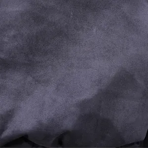 Macro view of soft dark grey suede fabric texture showing fine velvet details.