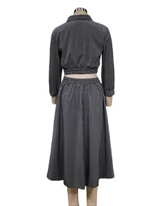 Back view of a black and white striped long-sleeve crop shirt and skirt set on mannequin