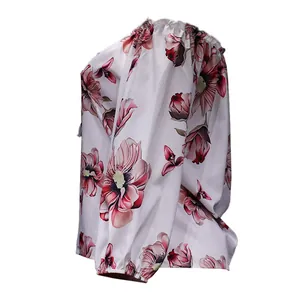 Close-up side view showing the elegant floral print on this off-the-shoulder long sleeve blouse
