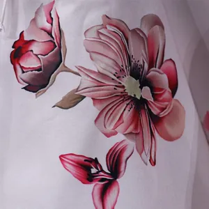 Close-up detail of vibrant pink floral print on white fabric for off-shoulder top