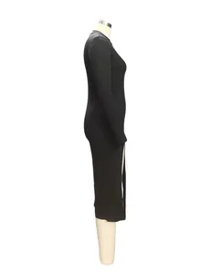 Side view of a black long sleeve ribbed dress featuring a mock neck and side slit