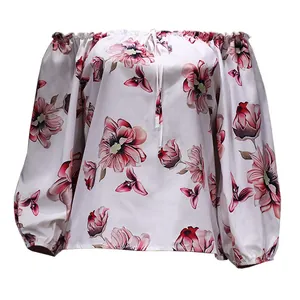 Close-up detail of women's off-the-shoulder floral print top with puff sleeves