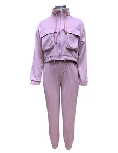 Front view of pink two-piece women's tracksuit with cargo pockets and joggers on mannequin.