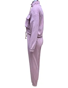 Side view of a pink two-piece women's casual tracksuit with cropped jacket and joggers