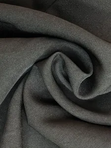 Detailed macro close-up of high-quality black twill suit fabric showing premium weave