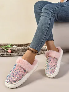 Primer plano de zapatillas rosas de lentejuelas con forro de felpa y suela gruesa