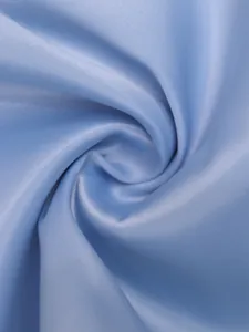 Macro detail of light blue silky fabric texture for solid color slim-fit women's top