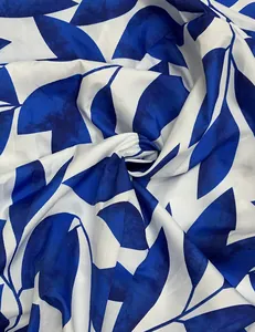 Primer plano de tela con estampado botánico de hojas azules y blancas para vestidos
