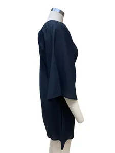Side view of navy blue cotton linen off-shoulder dress on a white mannequin for detail.