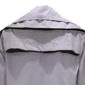 Close-up detail of the back storm flap on a light lavender mid-length trench coat