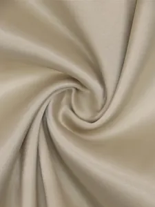 Close-up of elegant champagne beige satin fabric with smooth texture and luster