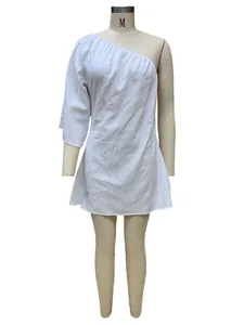 Detailed view of a white one-shoulder cotton linen loose dress displayed on a mannequin
