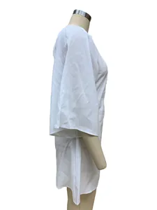 Side view of a white loose-fitting cotton linen dress on a mannequin display.