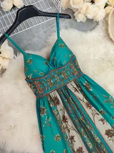 Close-up detail of a vintage floral print teal maxi dress with elegant spaghetti straps.