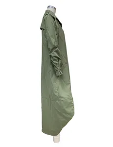 Side view of olive green long trench coat with decorative large lapel and grommets