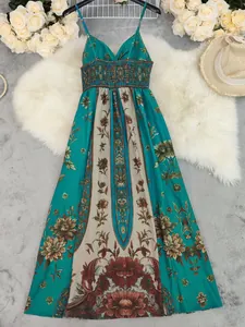 Detailed view of vintage teal floral maxi dress with elegant smocked bodice design