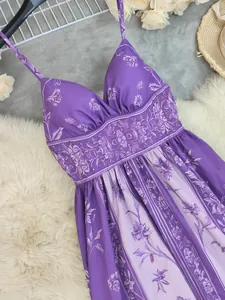 Close-up detail of a purple floral maxi dress with vintage print and spaghetti straps