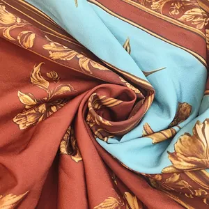 Macro view of vintage floral print fabric for summer maxi dress in terracotta and blue