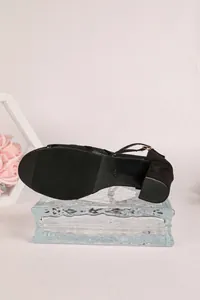 Detailed view of the anti-slip sole and sturdy block heel of black mesh sandals.