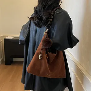 Vintage brown suede tote bag with decorative bead strap and soft pom-pom charm