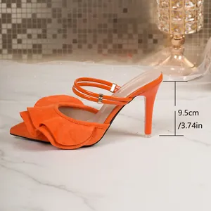 Detail view of vibrant orange ruffled pointed-toe high heel with a 9.5cm stiletto heel