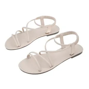 Detail view of beige Roman flat sandals with elastic straps and soft leather finish