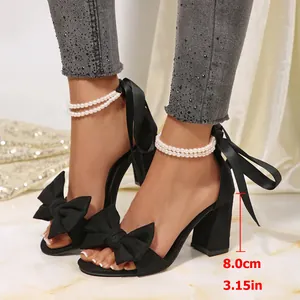 Detailed view of black satin chunky heel sandals with pearl straps and 8cm heel height
