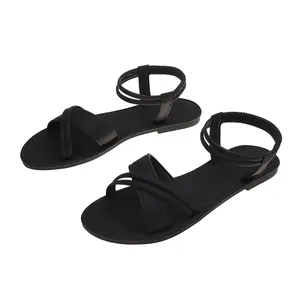 Detailed view of women's black flat Roman beach sandals with elastic straps