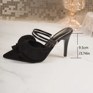 Detail shot of black ruffled pointed-toe high heels showing 9.5cm heel height