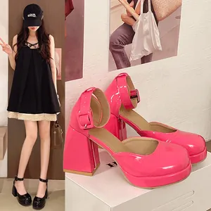 Close-up detail of hot pink patent leather Mary Jane platform shoes featuring a thick block heel