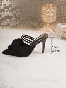 Detail of black ruffled pointed-toe high heel mule showing 9.5cm stiletto height