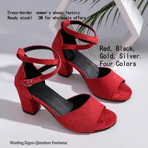 Detailed side view of elegant red suede block heel sandals with adjustable ankle straps.