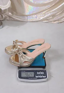 Detailed weight measurement view of gold glittery bow high heel sandals for women