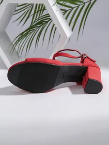 Detail of red suede chunky heel sandal featuring ankle strap and size 35 marking on sole