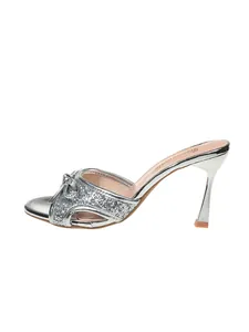 Side view of elegant silver glitter high heel mule with bow detail