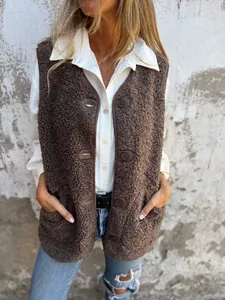 Detailed view of brown sherpa fleece vest with button closure worn over white shirt